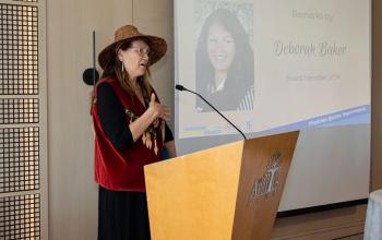 Deborah Baker, VCH Board Member, speaking to the graduates in her traditional Coastal First Nations clothing