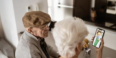 A couple look at a health app on a mobile phone.